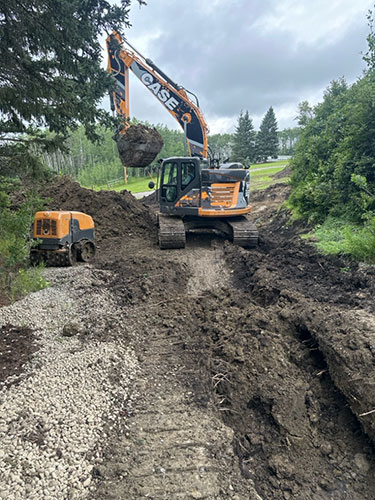 Image 1 - acreage development by Calgary's 2 Sons Excavating, waterline trenching.